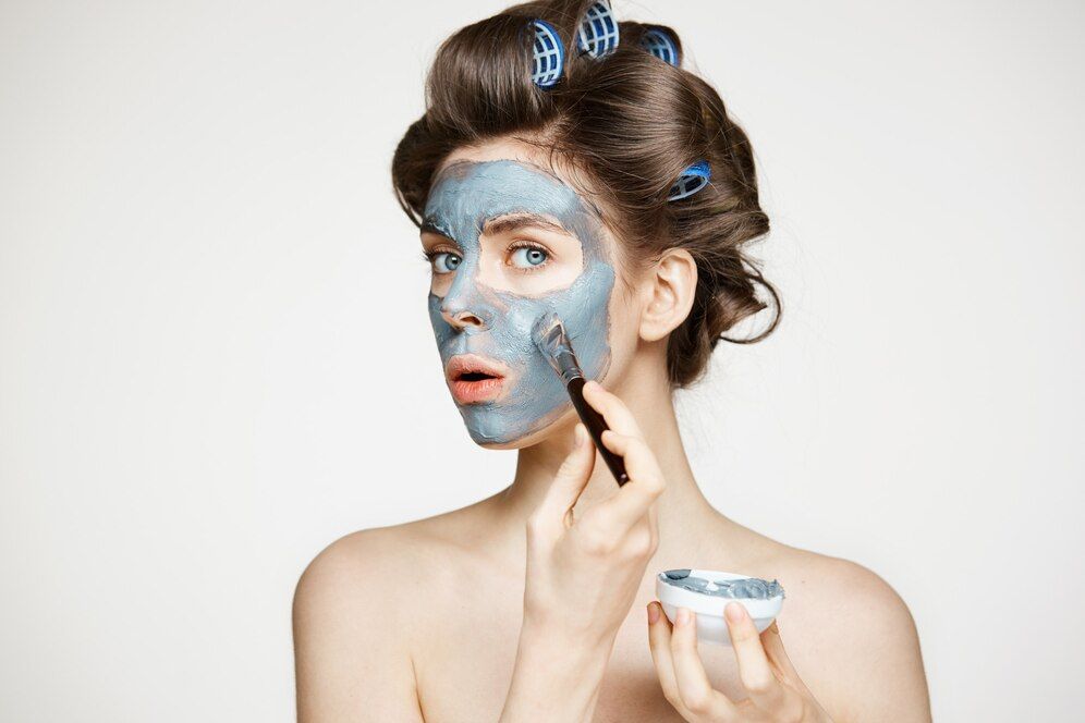 young-beautiful-woman-hair-curlers-covering-face-with-mack-facial-treatment-beauty-cosmetology-spa_176420-14189.jpg